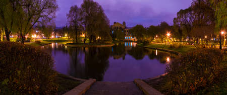 Dusk panoramic autumn view of park and pond in Yusupov Garden, Saint Petersburg, Russia