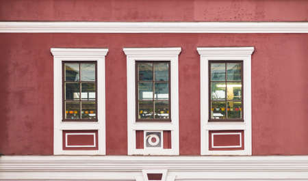Three windows in a row on facade of urban office building front view, St. Petersburg, Russia