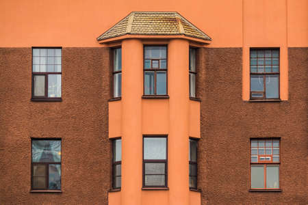 Several windows and bay window in a row on facade of urban apartment building front view, St....