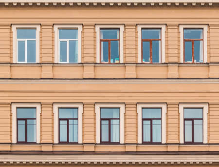 Several windows in a row on facade of urban office building front view, St. Petersburg, Russiaの写真素材