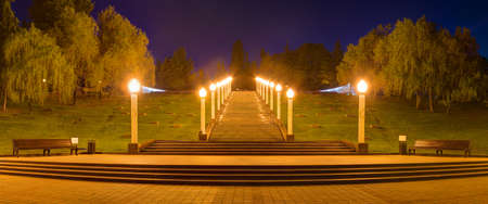 Panoramic view of Zavokzalnyy Memorial Complex with stairs and luminous lampposts at dusk, Sochi, Russiaの写真素材