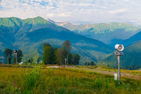 Landscape with distant ridges in blue haze in sunny day, Rosa Khutor, Russiaの写真素材