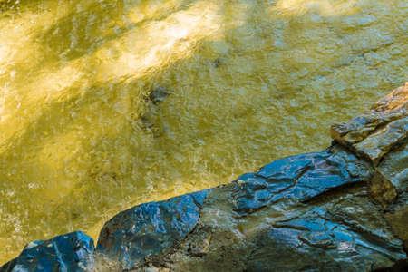 Abstract photo of water surface with ripple in reservoir of fountain with stone edgeの写真素材