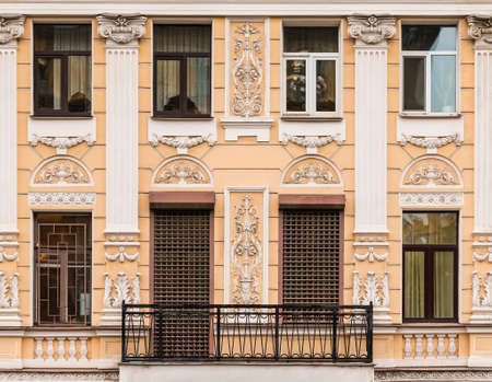 Several windows in a row and balcony on facade of urban apartment building front view, St. Petersburg, Russiaの写真素材