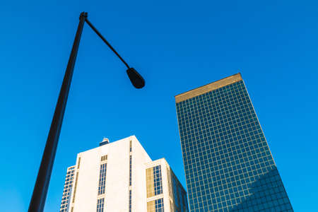 Bottom view of streetlight and office skyscrapers on the background of clear sky, Atlanta, USAの写真素材