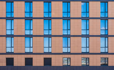 Many windows in a row on facade of modern urban building front view, St. Petersburg, Russia