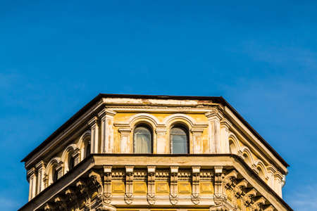 Low angle view of the attic of the urban historic building on the background of clear sky, Saint Petersburg, Russiaの写真素材