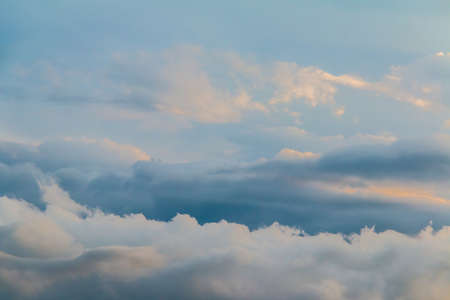 Beautiful cloudscape with blue and gray contrasting clouds during thunderstormの写真素材
