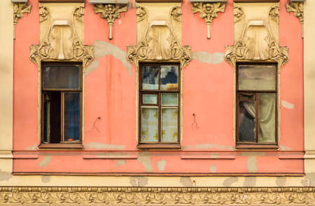 Three windows in a row on the facade of the urban historic building front view, Saint Petersburg, Russiaのeditorial素材