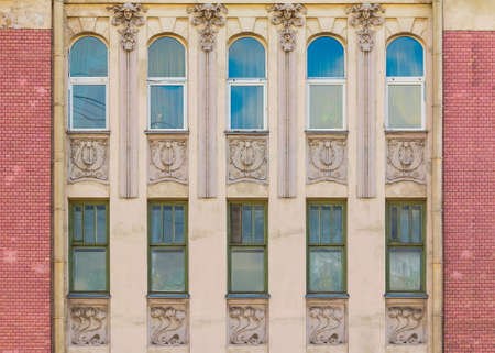 Several windows in a row on the facade of the urban historic building front view, Saint Petersburg,...