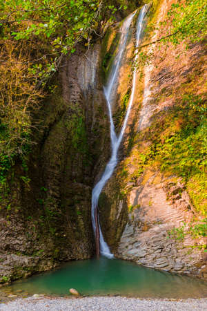 Orekhovsky Waterfall of Bezumenka River in sunny autumn day, Sochi, Russiaの写真素材