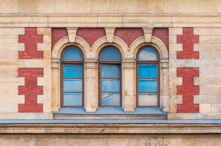 Three windows in a row on the facade of the urban historic building front view, Saint Petersburg,...