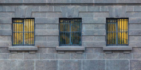 Three windows in a row on the facade of the urban historic building front view, Saint Petersburg, Russiaの写真素材