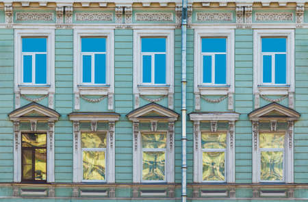 Several windows in a row on the facade of the urban historic building front view, Saint Petersburg, Russiaの写真素材