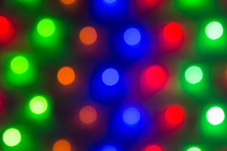 Abstract image of defocused varicolored round lights in a row closeupの写真素材
