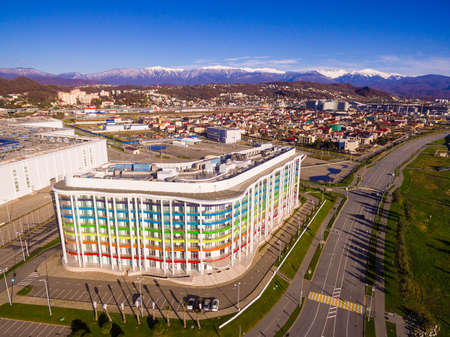 Drone view of apartment buildings at Triumphal street and ridge of mountains on the background in sunny day, Sochi, Russiaのeditorial素材