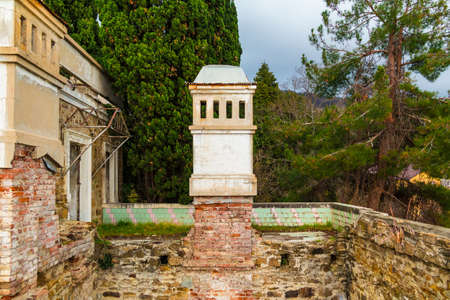 Chimney of abandoned old mansion called Dacha Kvitko among the thicket in overcast day, Sochi, Russiaの写真素材
