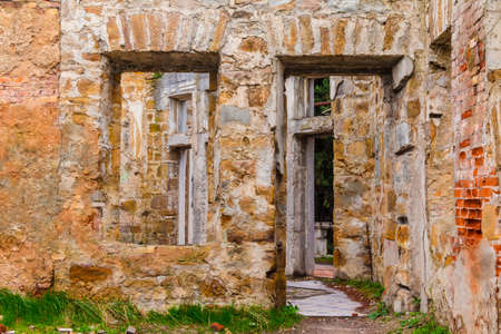 The inner room with gaps in the wall of the abandoned old mansion called Dacha Kvitko, Sochi, Russiaの写真素材