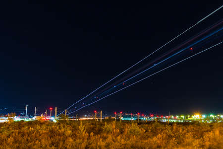 Light trails of landing plane on the background of night sky with stars, Adler, Sochi, Russiaの写真素材