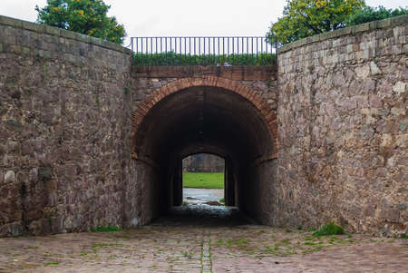Barcelona, Catalonia, Spain - November 16, 2018: Perspective symmetric view of a stone wall with a tunnel in the Montjuic Castleのeditorial素材