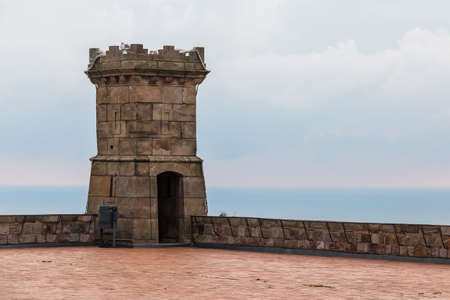 Barcelona, Catalonia, Spain - November 16, 2018: The tower of the Montjuic Castle on the upper area closeup in cloudy dayのeditorial素材