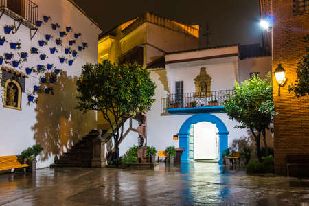 Barcelona, Catalonia, Spain - November 17, 2018: Beautiful night view of an illuminated square, buildings and tangerine trees in the open-air Poble Espanyol architectural museumのeditorial素材