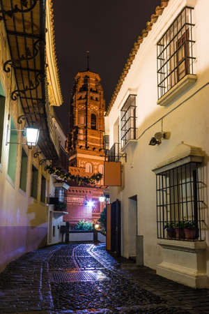 Barcelona, Catalonia, Spain - November 17, 2018: Beautiful night view of an illuminated street, buildings and bell tower in the open-air Poble Espanyol architectural museumのeditorial素材