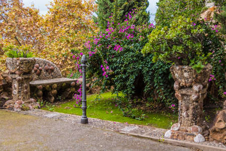 The beautiful terrace with a flower beds and ornate stone bench on the Montjuic Cemetery in autumn day, Barcelona, Catalonia, Spainの写真素材
