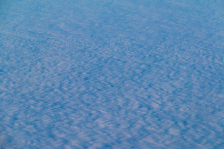 View from the porthole of airplane of a beautiful cloudscapeの写真素材