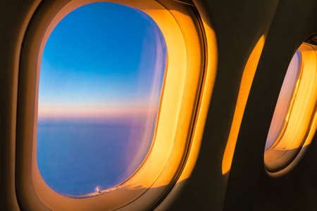 Sunlight beautifully lying on the portholes of the aircraft at sunsetの写真素材
