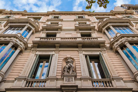 Worm's-eye view of a historic urban building on the Passeig de Gracia on the background of cloudy sky, Barcelona, Catalonia, Spainのeditorial素材