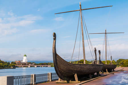 Two Viking ships on the embankment of the Salakkalahti Bay on the background of the Vyborg Castle in Vyborg, Leningrad Oblast, Russiaのeditorial素材