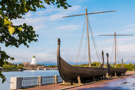 Two Viking ships on the embankment of the Salakkalahti Bay on the background of the Vyborg Castle in Vyborg, Leningrad Oblast, Russiaの写真素材
