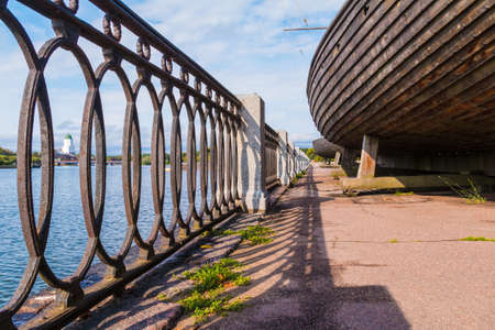 Low-angle view of the fence of the embankment of Salakkalahti Bay and hulls of Viking ships, Vyborg, Leningrad Oblast, Russiaの写真素材