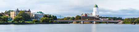 Long-exposure panoramic view of the Vyborg Castle, the Petrovsky Bridge and apartment buildings in overcast day, Vyborg, Leningrad Oblast, Russiaの写真素材
