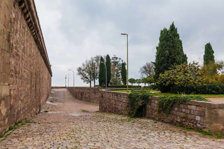 Barcelona, Catalonia, Spain - November 16, 2018: Perspective view of the pavement and fortress of the Montjuic Castle in overcast dayのeditorial素材