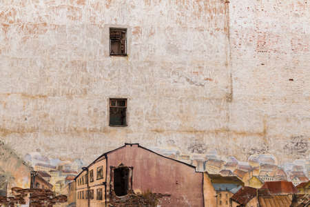 Vyborg, Leningrad Oblast, Russia - September 13, 2018: Wall of an abandoned building with graffiti depicting old European streets and apartment buildingsのeditorial素材