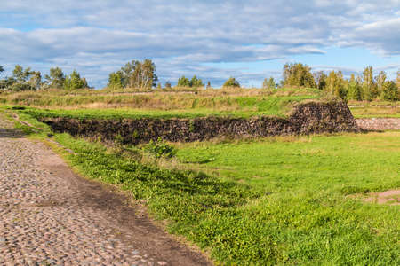 Stone walls and moats covered by the grass in Annenkrone in sunny day, Vyborg, Leningrad Oblast, Russiaの写真素材