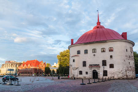Vyborg, Leningrad Oblast, Russia - September 12, 2018: Beautiful view of the Market Square and the Round Tower at sunsetのeditorial素材