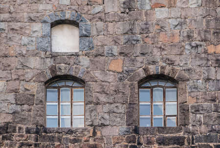 Several windows in the stone wall of the Vyborg Castle front view, Vyborg, Leningrad Oblast, Russiaの写真素材