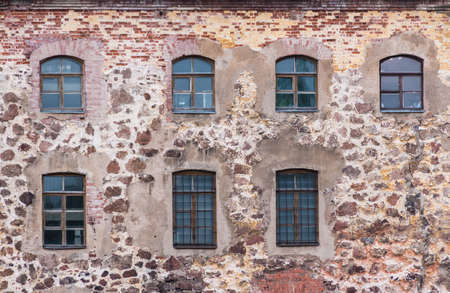 Several windows in a row in the stone wall of the Vyborg Castle front view, Vyborg, Leningrad Oblast, Russiaの写真素材