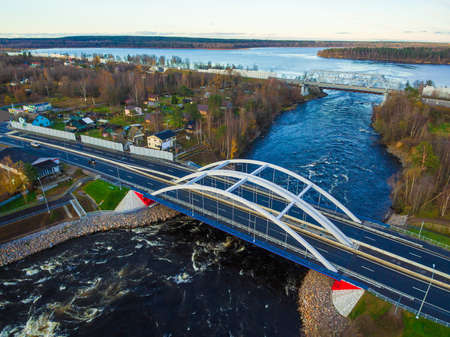 Drone view of the Vuoksi River Bridge and the settlement in autumn day, Losevo, Leningrad Oblast, Russiaの写真素材