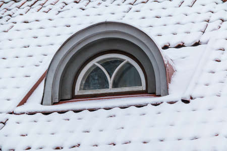 The window on the roof of attic in the building in a classic style, Tallinn, Estoniaの写真素材