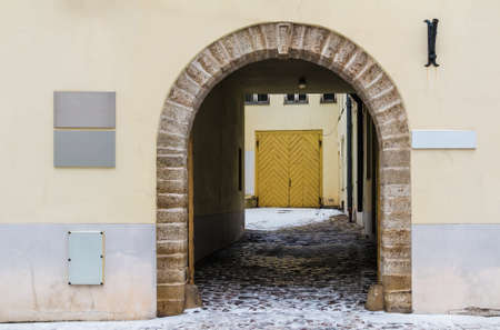 Arch in the urban historic building front view, Tallinn, Estoniaの写真素材
