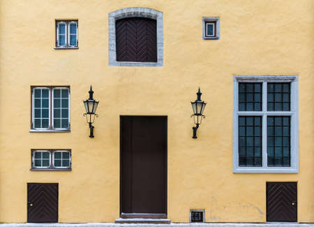 Several windows and door on facade of the urban historic building front view, Tallinn, Estoniaの写真素材