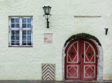 Two doors and window on facade of the urban historic building front view, Tallinn, Estoniaの写真素材