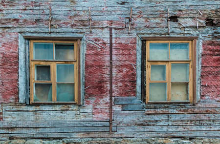 Two windows on facade of the urban historic wooden building front view, Tallinn, Estoniaの写真素材