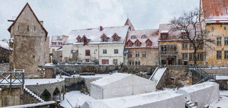 Panoramic view of buildings and the open air scene of the Tallinn City Theater in snowy winter day, Tallinn Old Town, Estoniaの写真素材