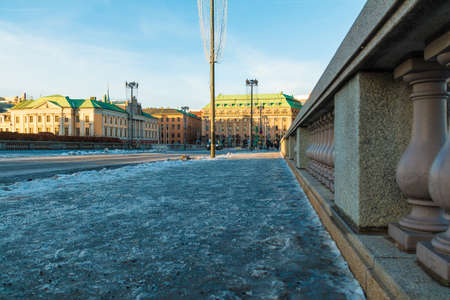Stockholm, Sweden - December 26, 2018: Low-angle perspective view of the Norrbro Bridge and historical buildings on the Gustaf Adolf's Square in sunny winter dayのeditorial素材