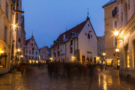 Tallinn, Estonia - December 25, 2018: Beautiful long-exposure view of old buildings on illuminated crossroad of the several streets in the Tallinn Old Town in overcast winter day at duskのeditorial素材